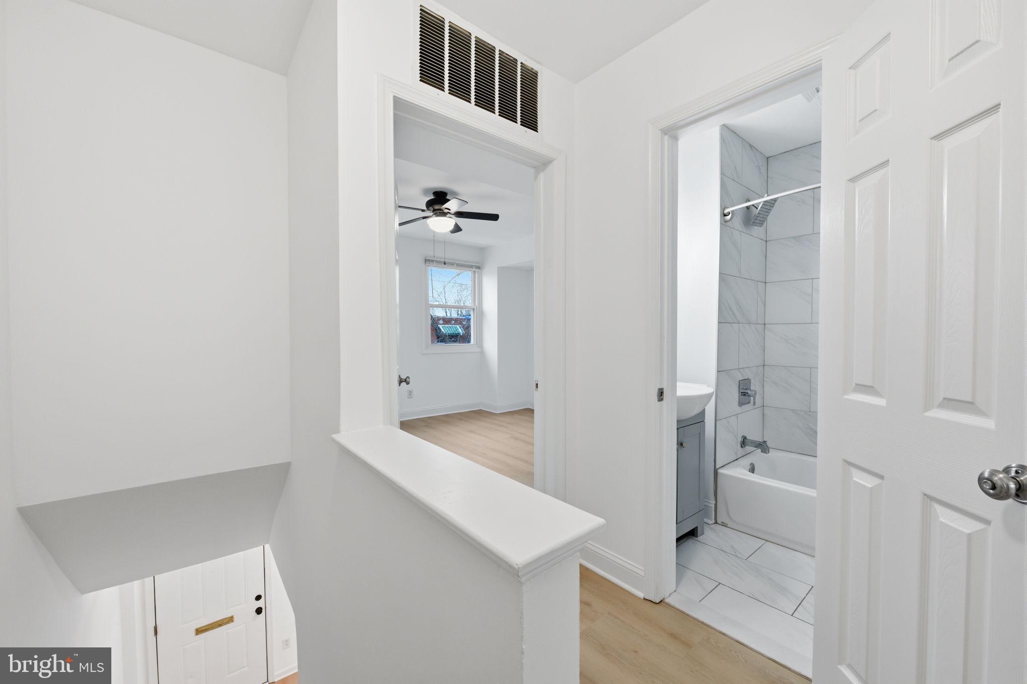 2242 16th Street Northeast Washington, DC 20018 - Photo 21 of 41 a bathroom with a sink and mirror with bathtub
