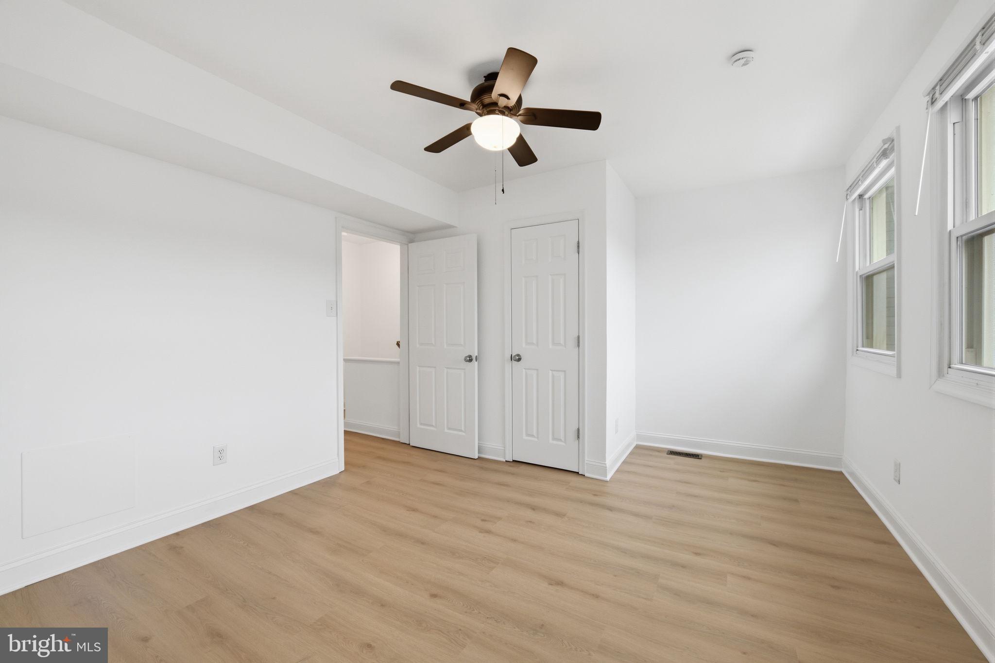 2242 16th Street Northeast Washington, DC 20018 - Photo 24 of 41 an empty room with wooden floor ceiling fan and windows