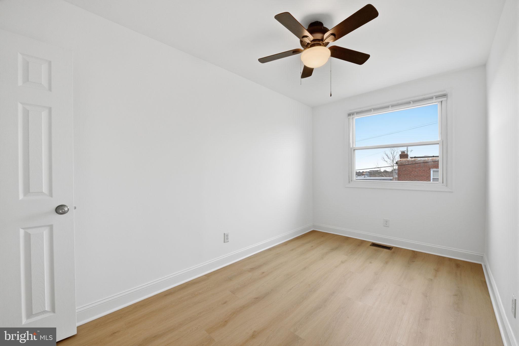 2242 16th Street Northeast Washington, DC 20018 - Photo 27 of 41 an empty room with a window and a ceiling fan