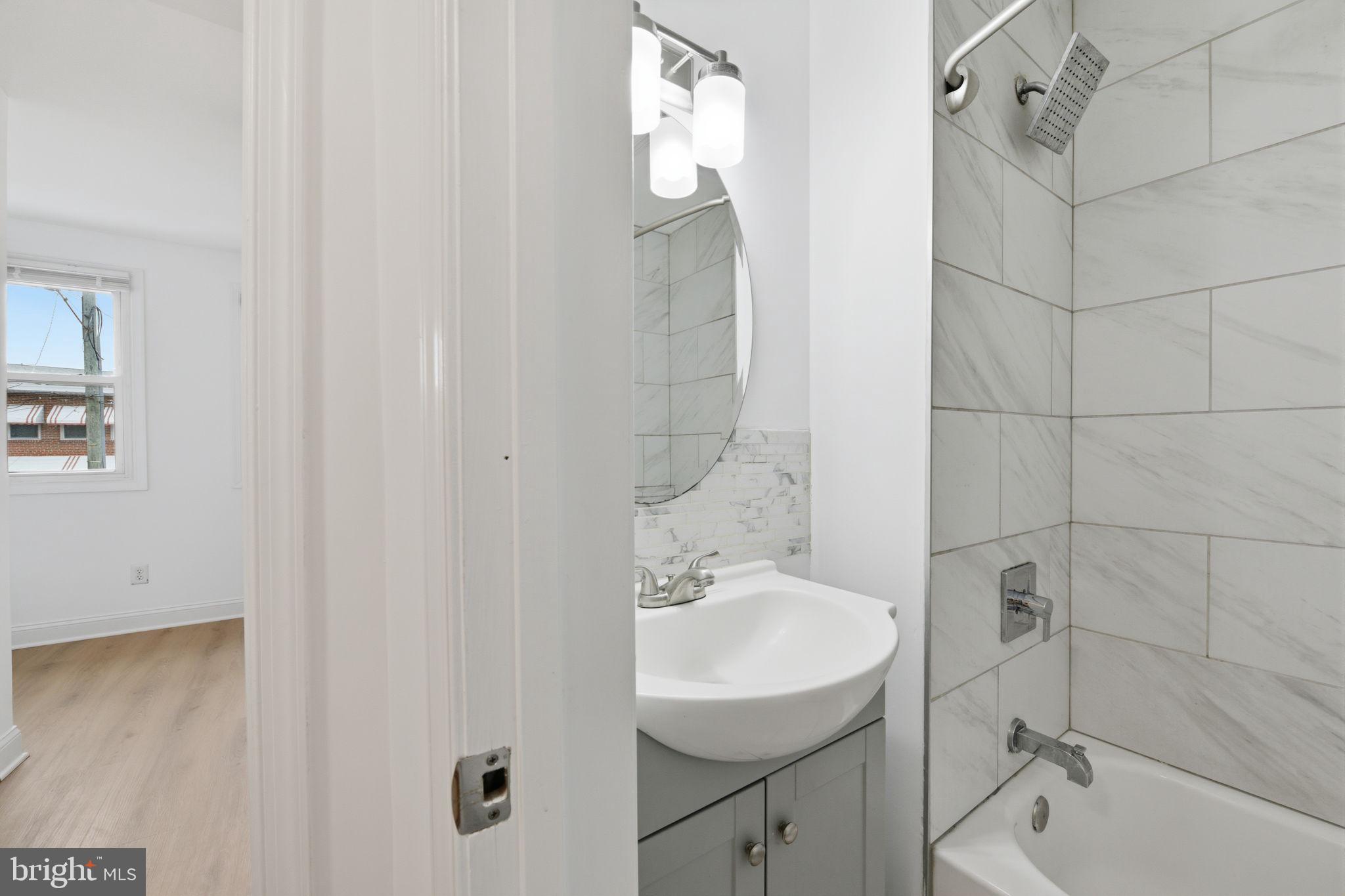 2242 16th Street Northeast Washington, DC 20018 - Photo 32 of 41 a bathroom with a sink toilet and shower