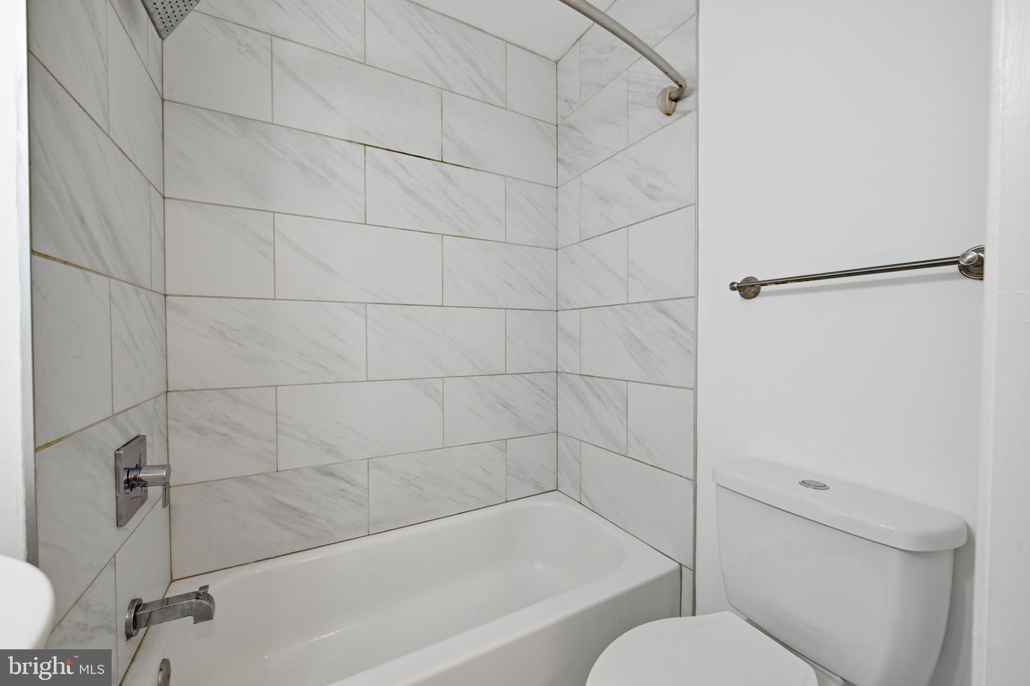 2242 16th Street Northeast Washington, DC 20018 - Photo 33 of 41 a bathroom with a bathtub and a shower