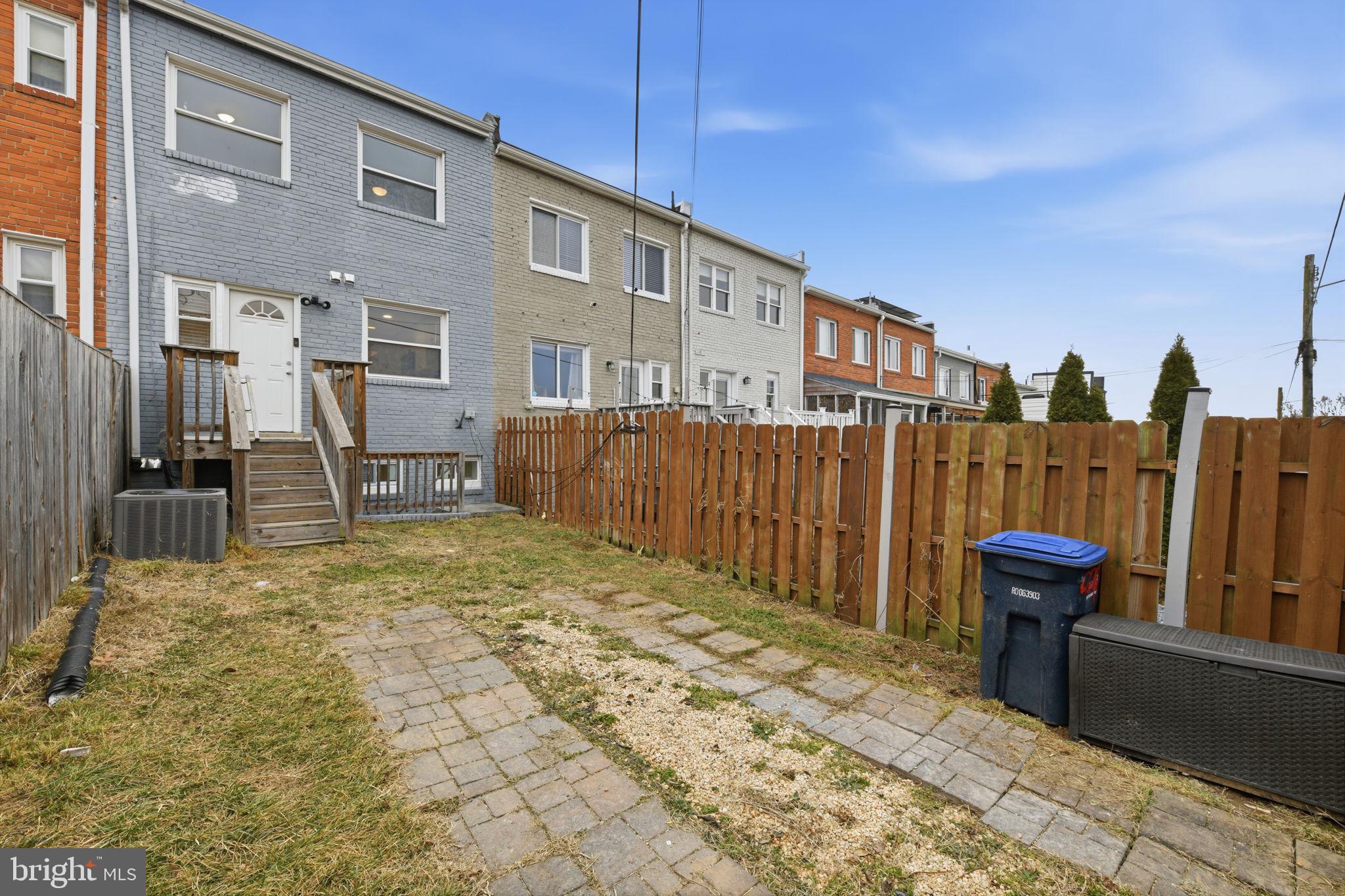 2242 16th Street Northeast Washington, DC 20018 - Photo 35 of 41 a backyard of a house with barbeque oven table and chairs