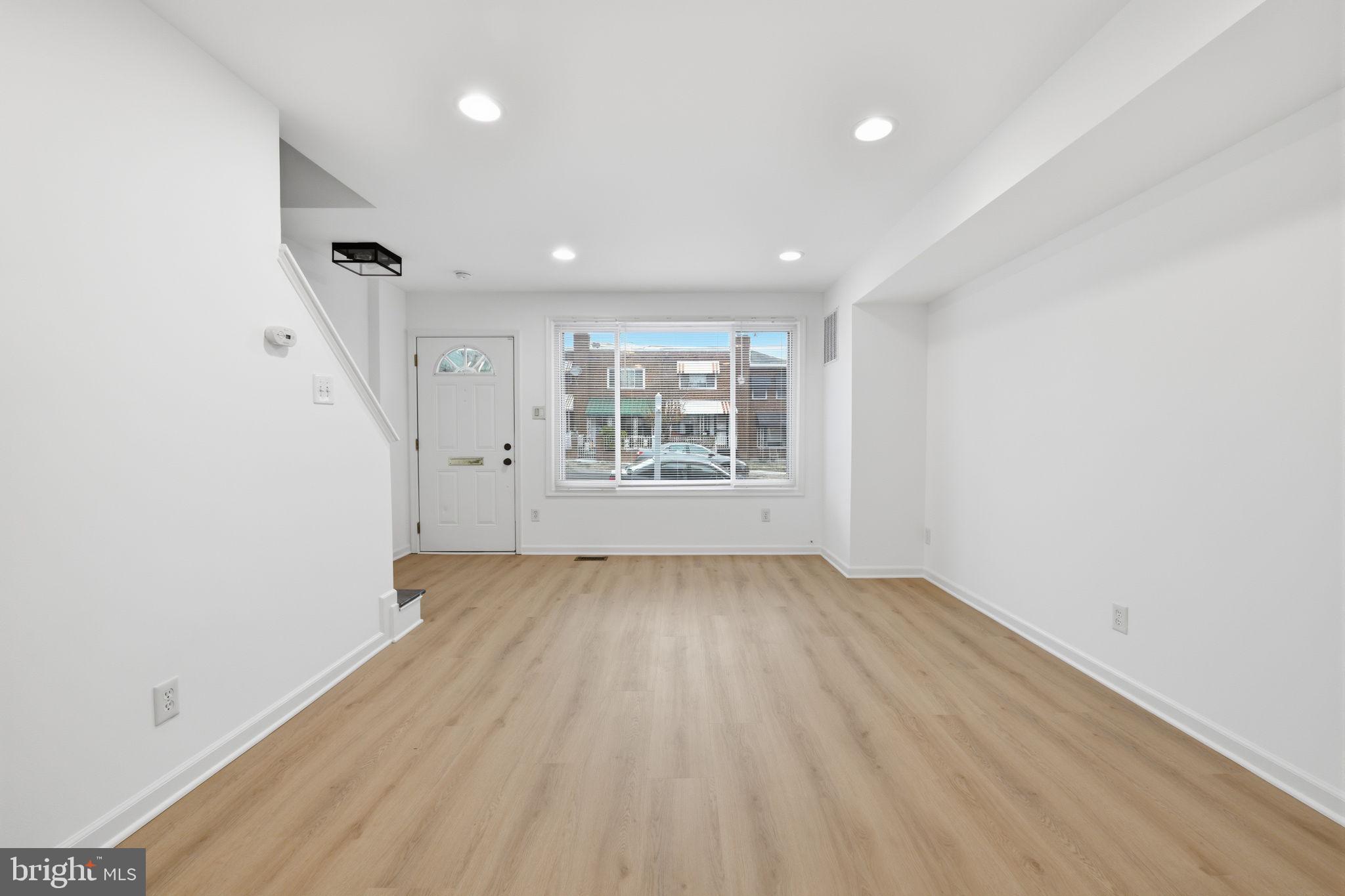 2242 16th Street Northeast Washington, DC 20018 - Photo 7 of 41 an empty room with wooden floor and windows