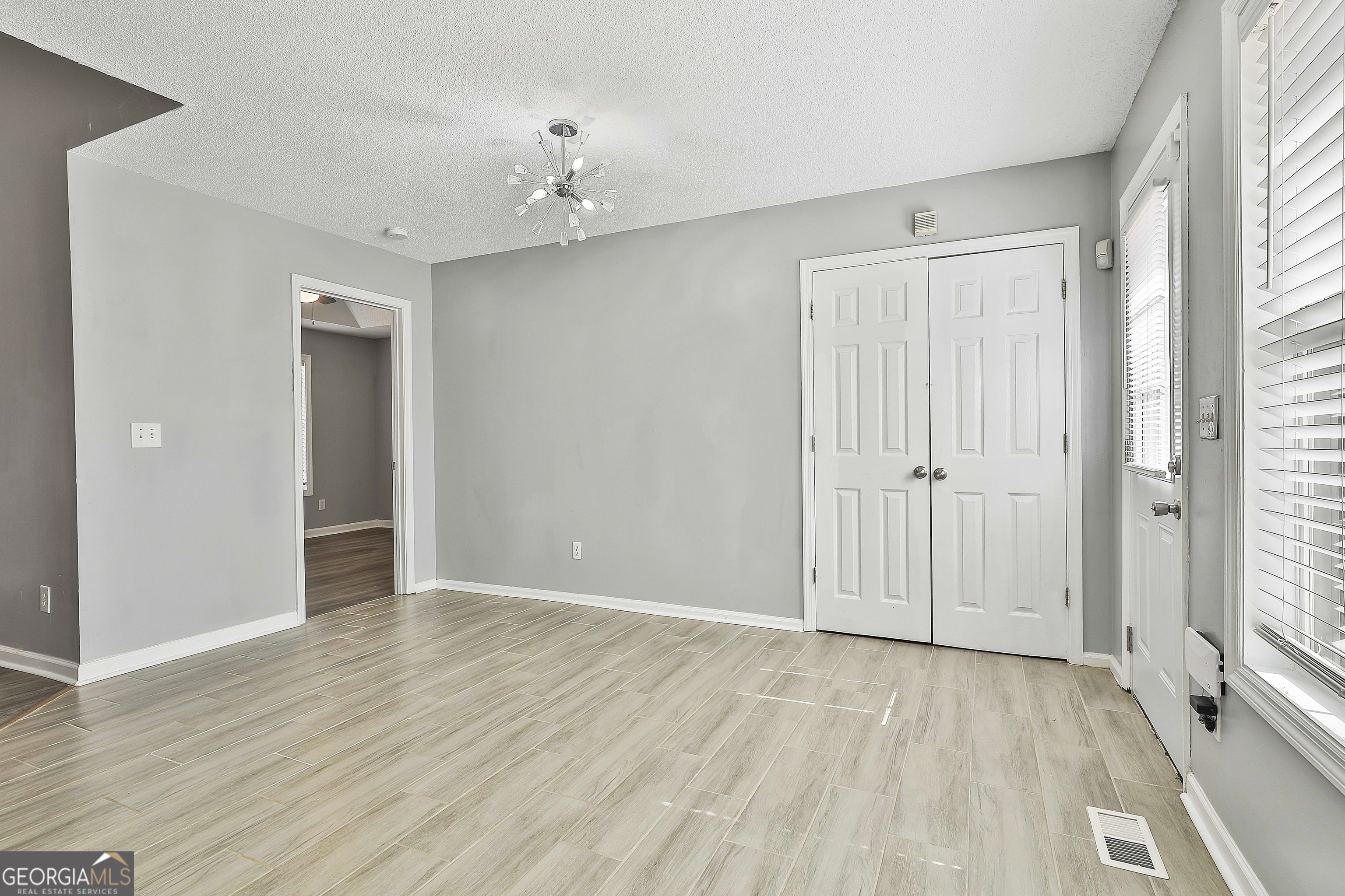 1209 North Hampton Drive Hampton, GA 30228 - Photo 17 of 39 a view of an empty room with wooden floor and a window