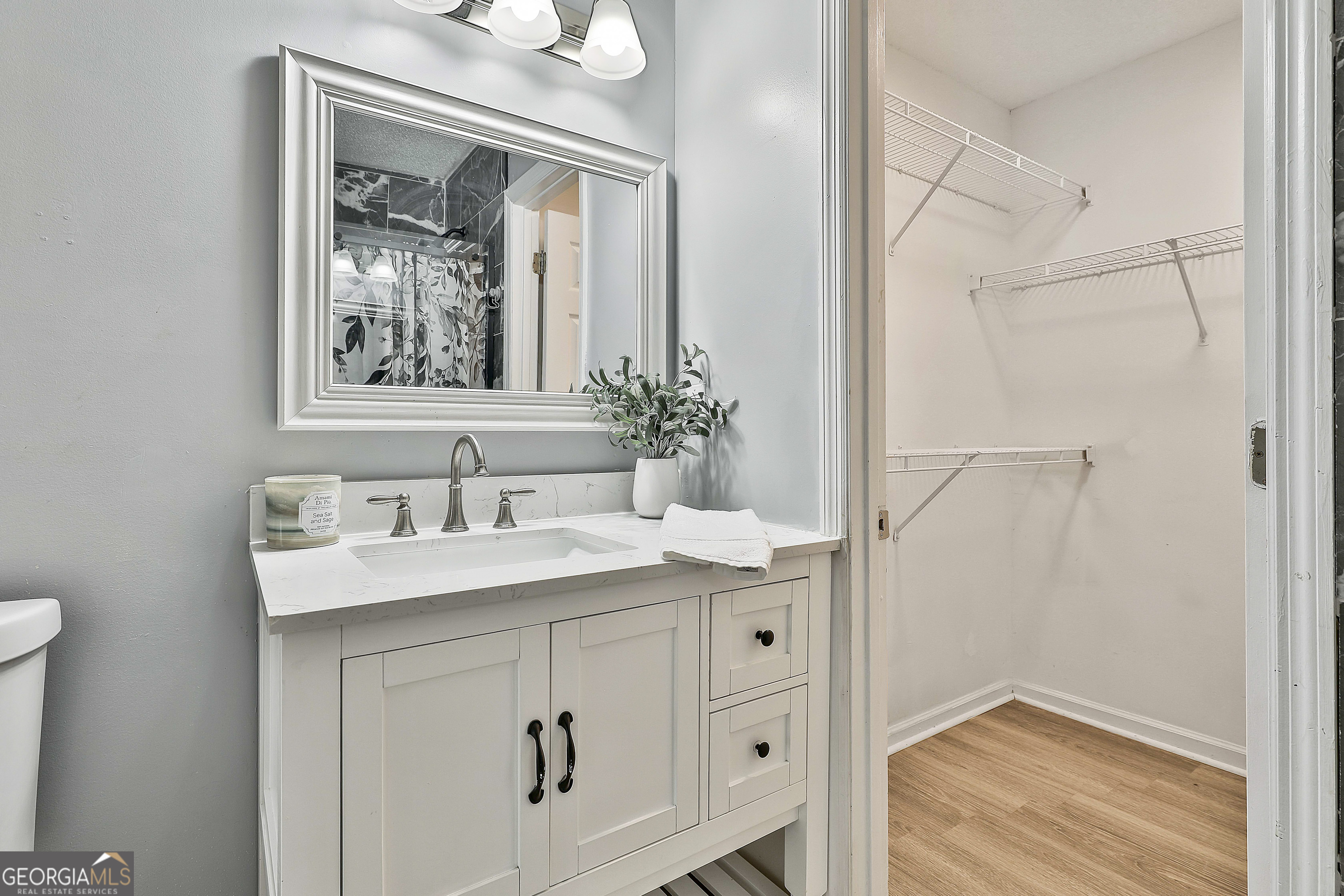 1209 North Hampton Drive Hampton, GA 30228 - Photo 22 of 39 a bathroom with a sink vanity and a mirror