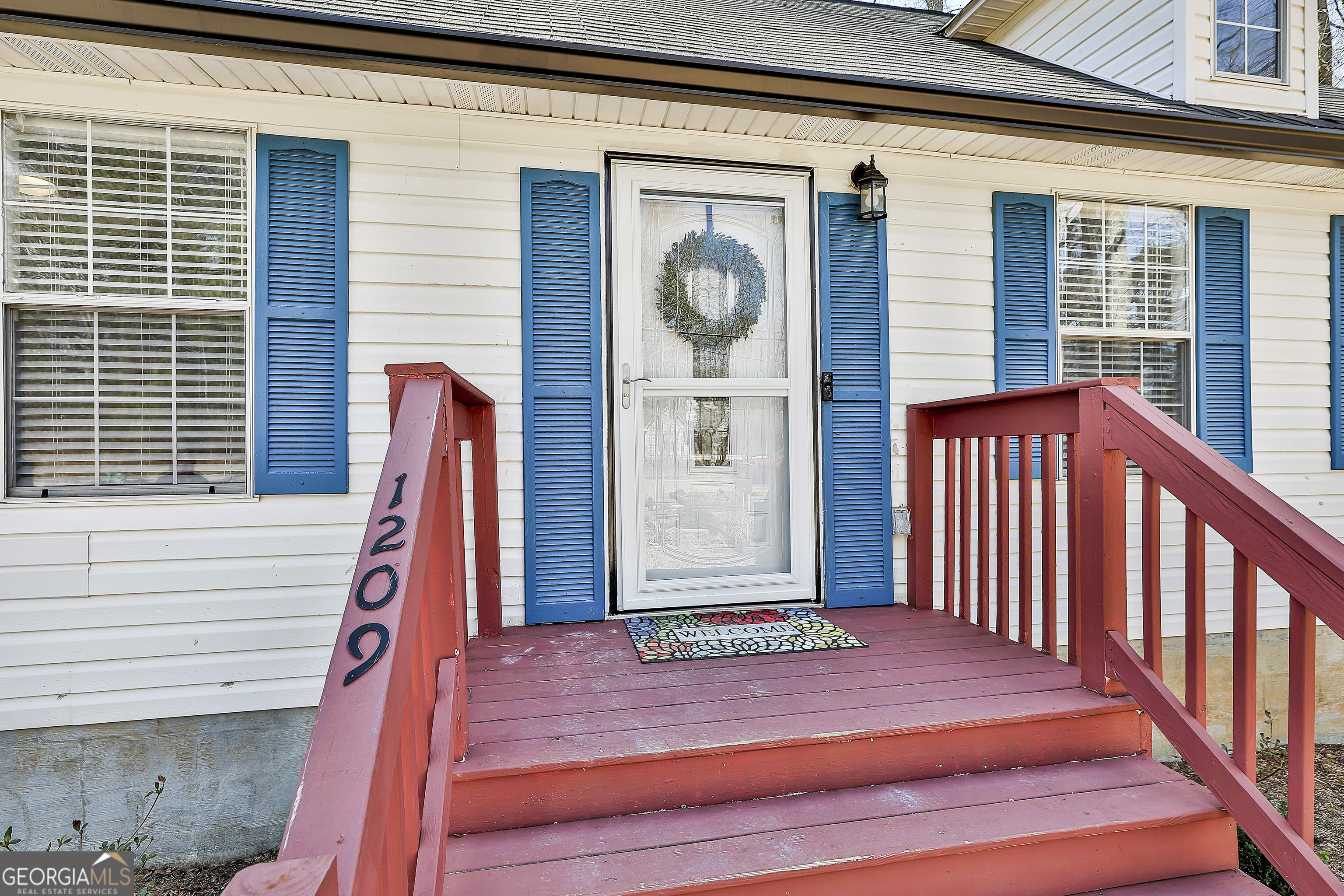 1209 North Hampton Drive Hampton, GA 30228 - Photo 5 of 39 a view of a house with a porch