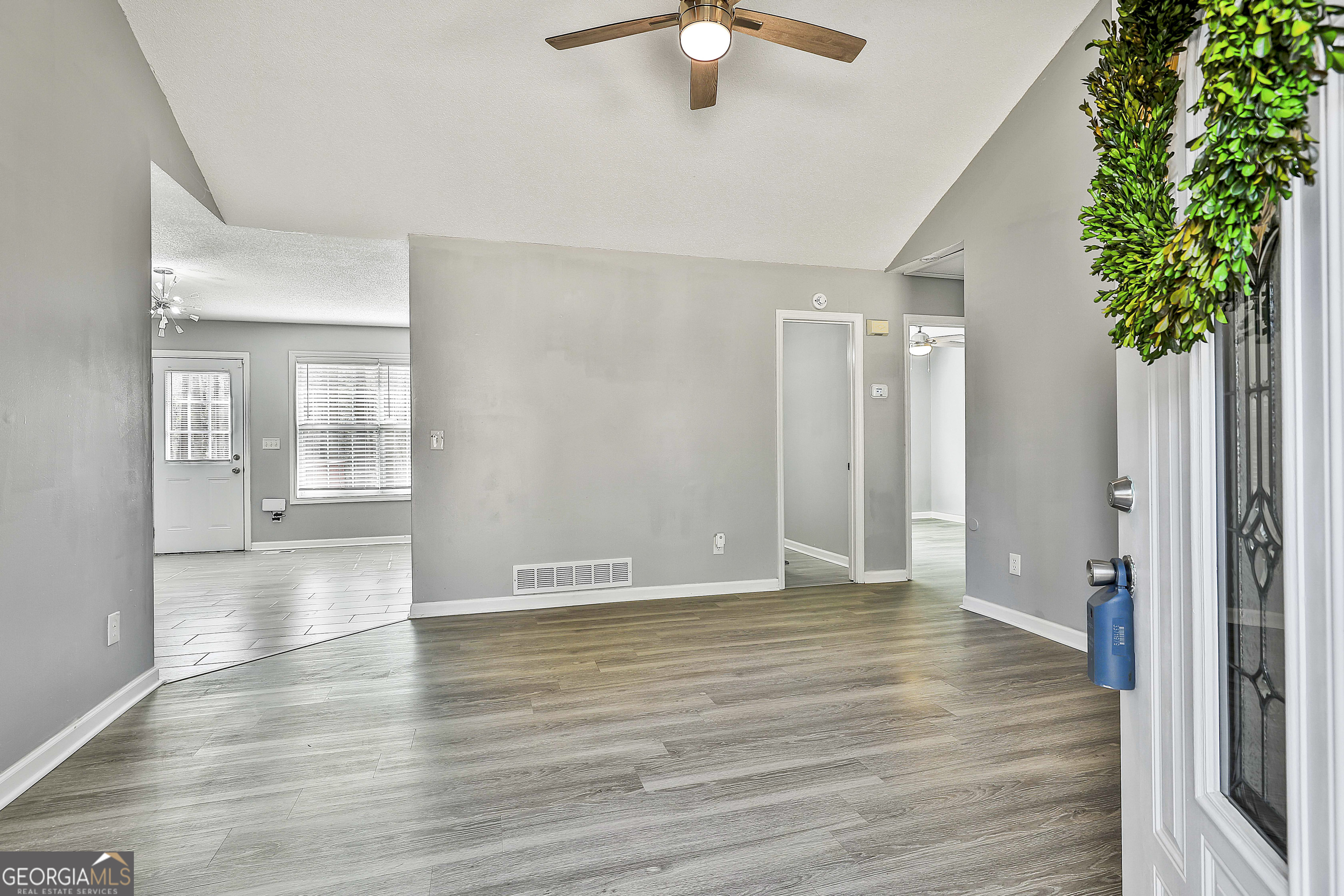 1209 North Hampton Drive Hampton, GA 30228 - Photo 6 of 39 a view of an empty room with wooden floor and a window