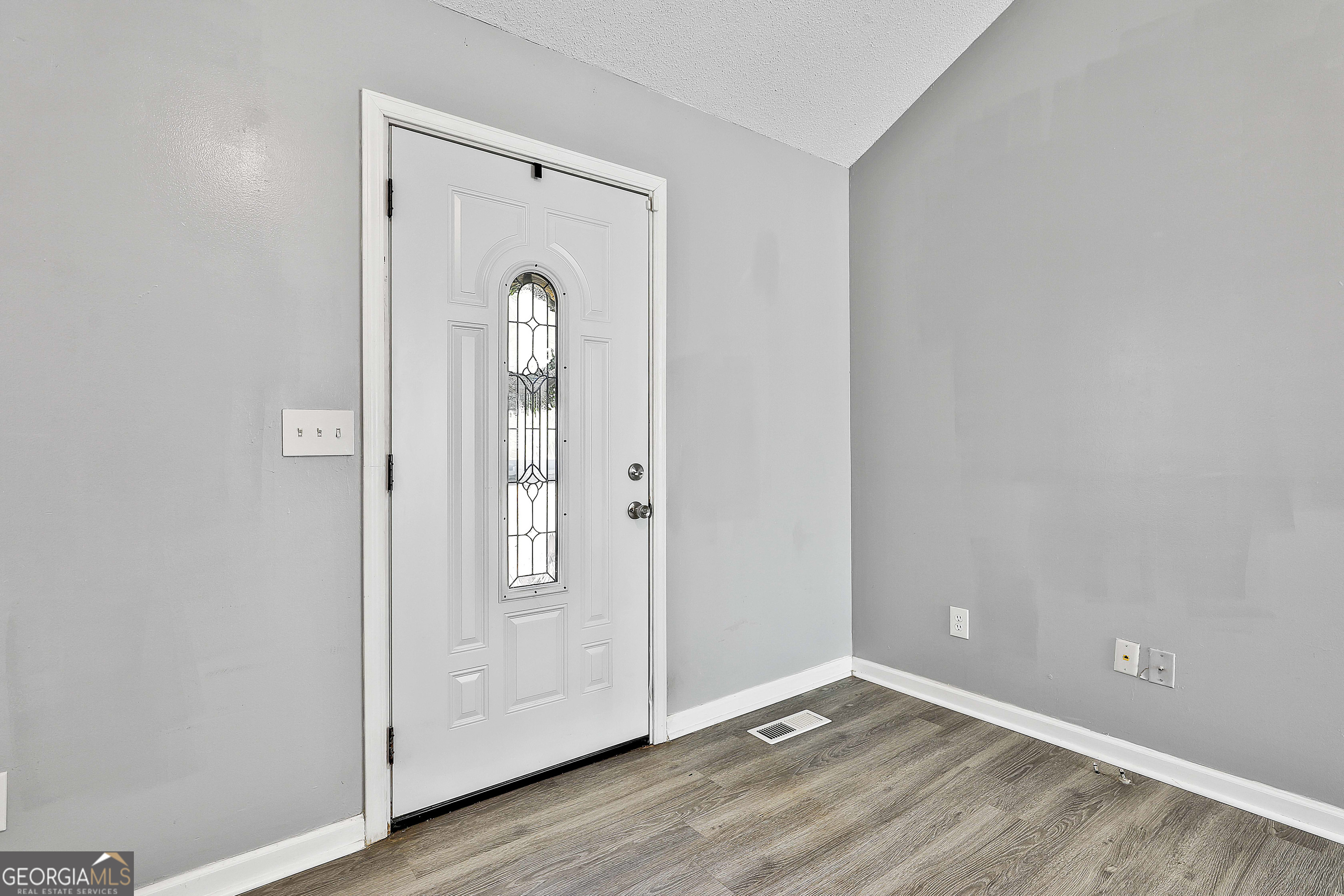 1209 North Hampton Drive Hampton, GA 30228 - Photo 7 of 39 an empty room with wooden floor and mirror