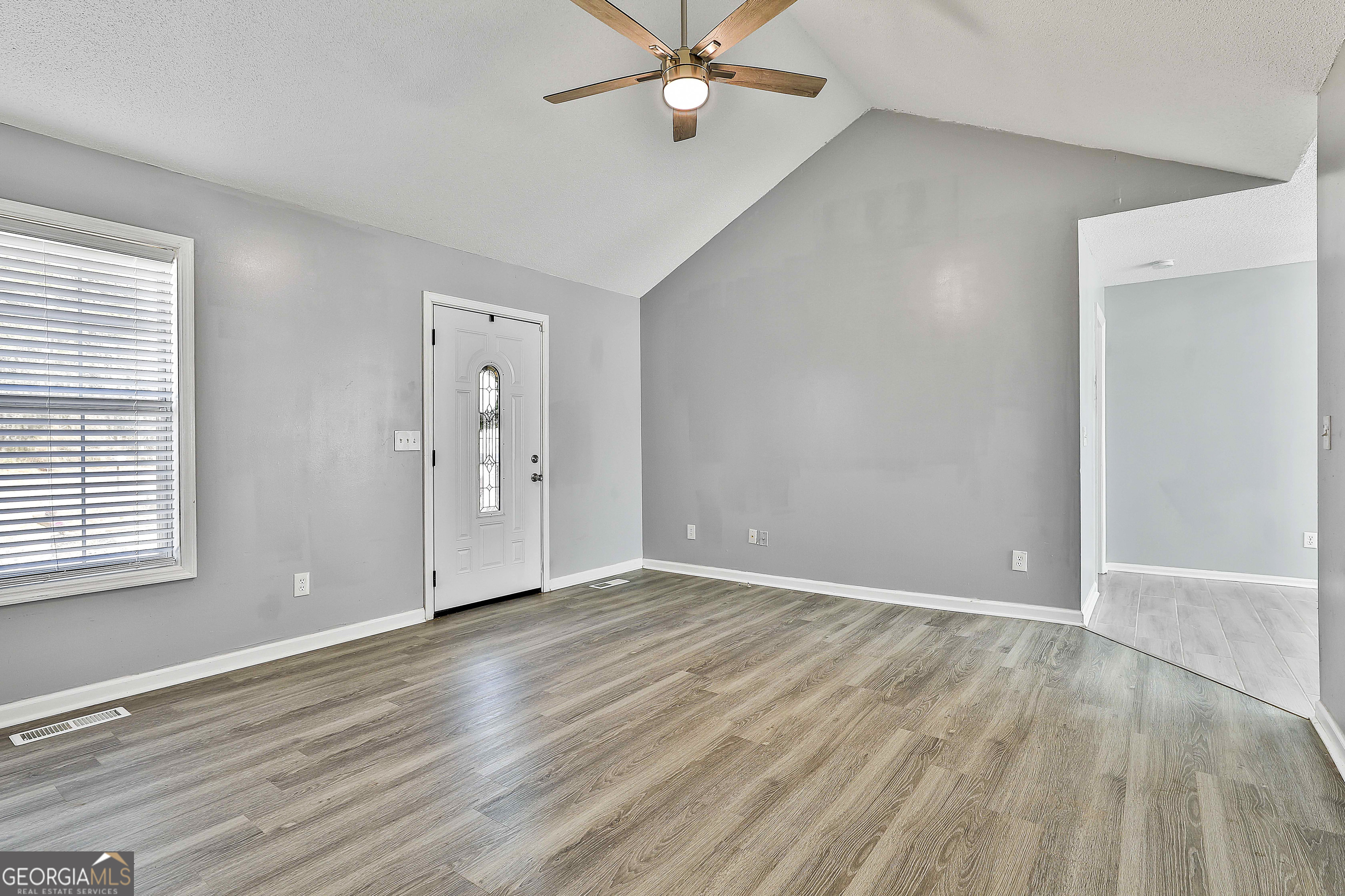 1209 North Hampton Drive Hampton, GA 30228 - Photo 10 of 39 wooden floor in an empty room with a window
