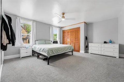 a spacious bedroom with a bed and a large window