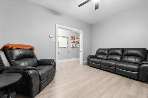 a living room with furniture a couch and a potted plant