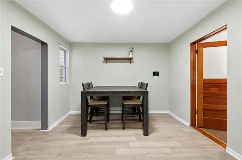 a view of a workspace with furniture and wooden floor