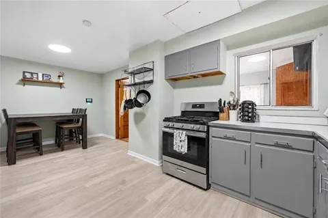 a kitchen with stainless steel appliances granite countertop a stove and a refrigerator
