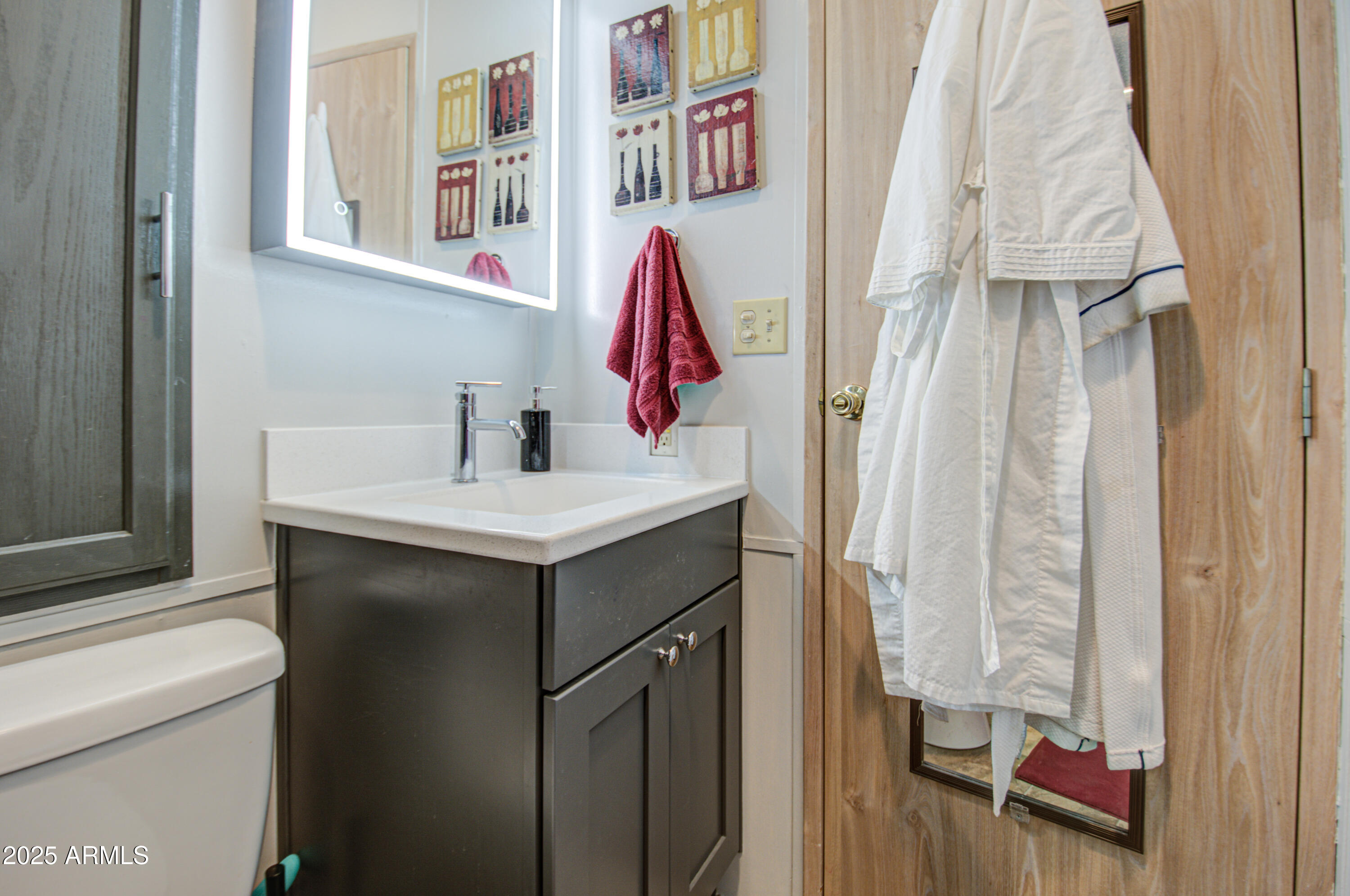 7750 East Broadway Road, Unit 475 Mesa, AZ 85208 - Photo 14 of 34 a bathroom with a sink and a mirror