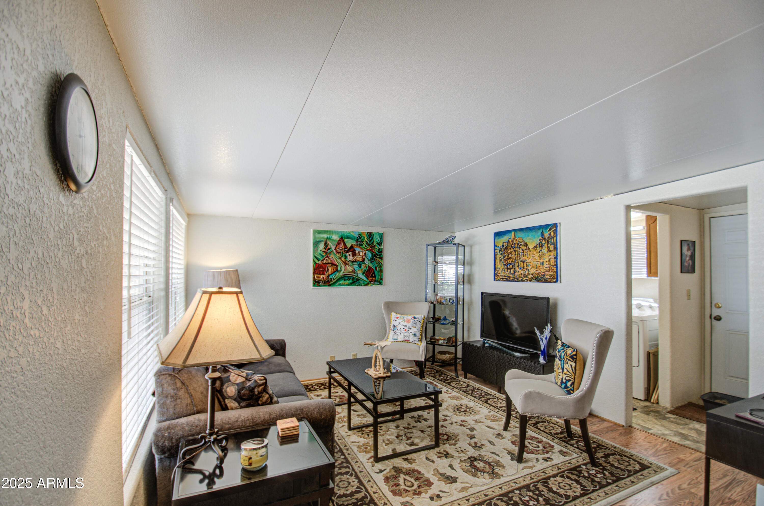 7750 East Broadway Road, Unit 475 Mesa, AZ 85208 - Photo 15 of 34 a living room with furniture a flat screen tv and a fireplace
