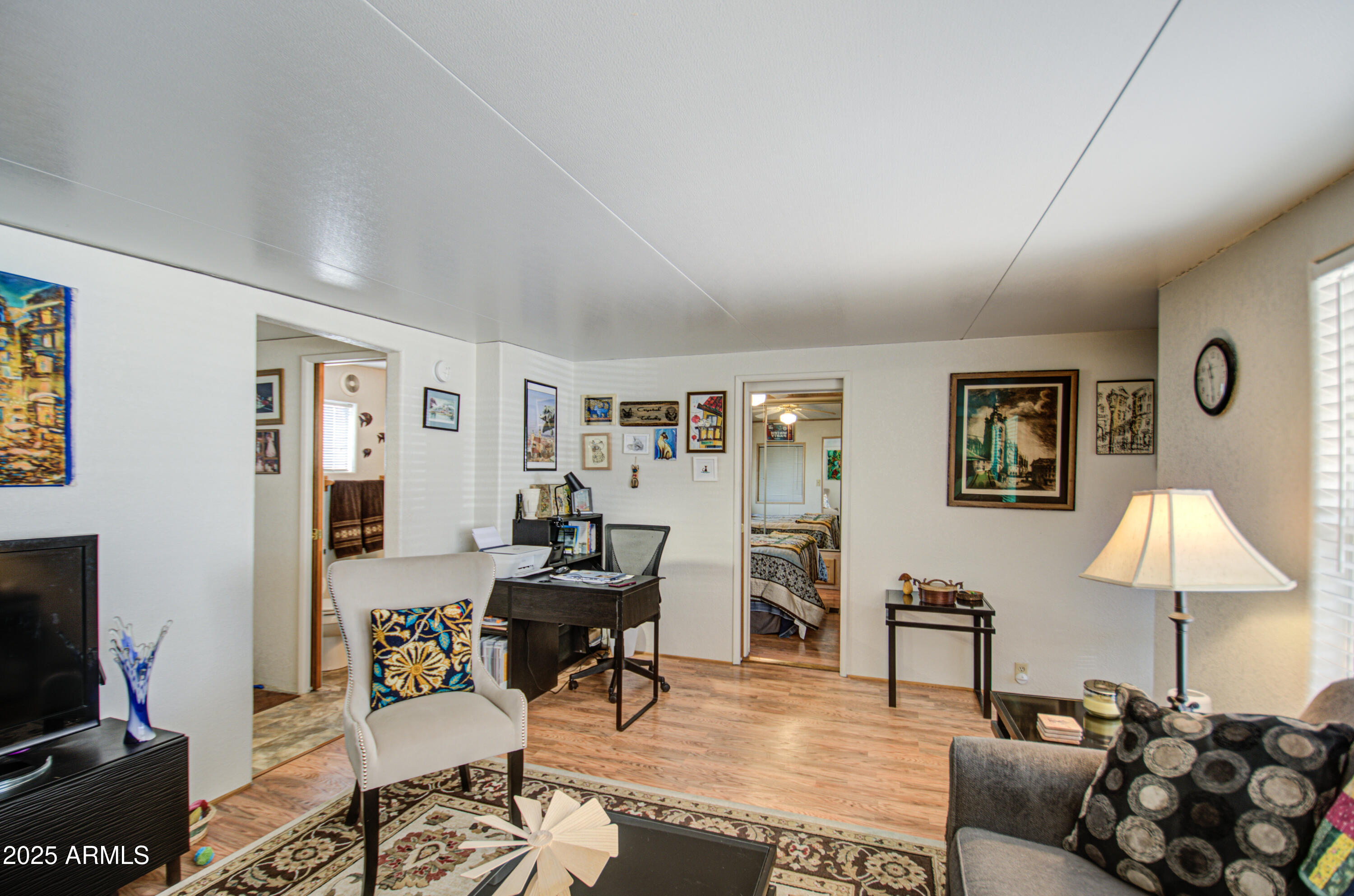 7750 East Broadway Road, Unit 475 Mesa, AZ 85208 - Photo 16 of 34 a living room with furniture and a flat screen tv