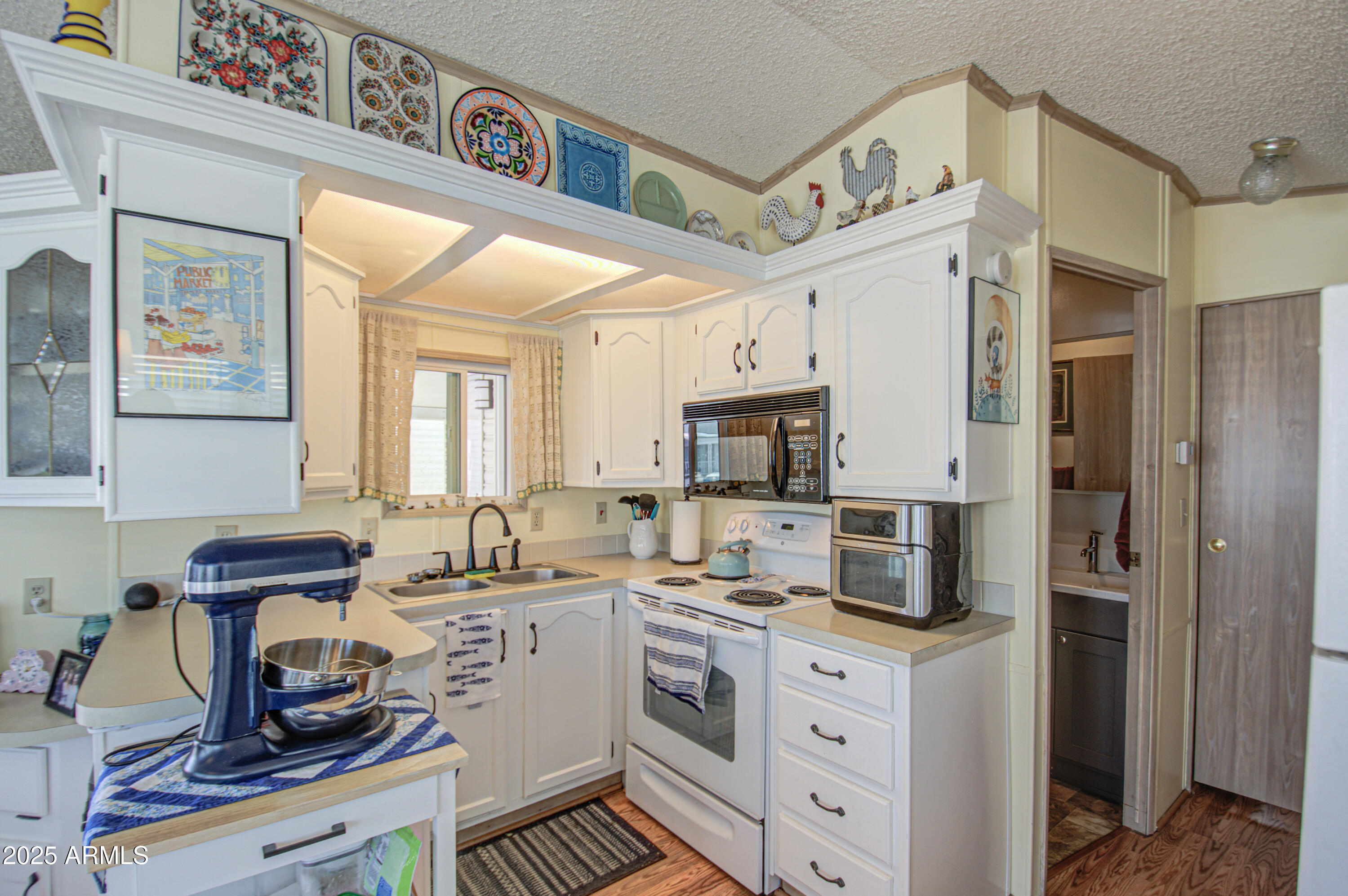 7750 East Broadway Road, Unit 475 Mesa, AZ 85208 - Photo 2 of 34 a kitchen with a sink cabinets and appliances