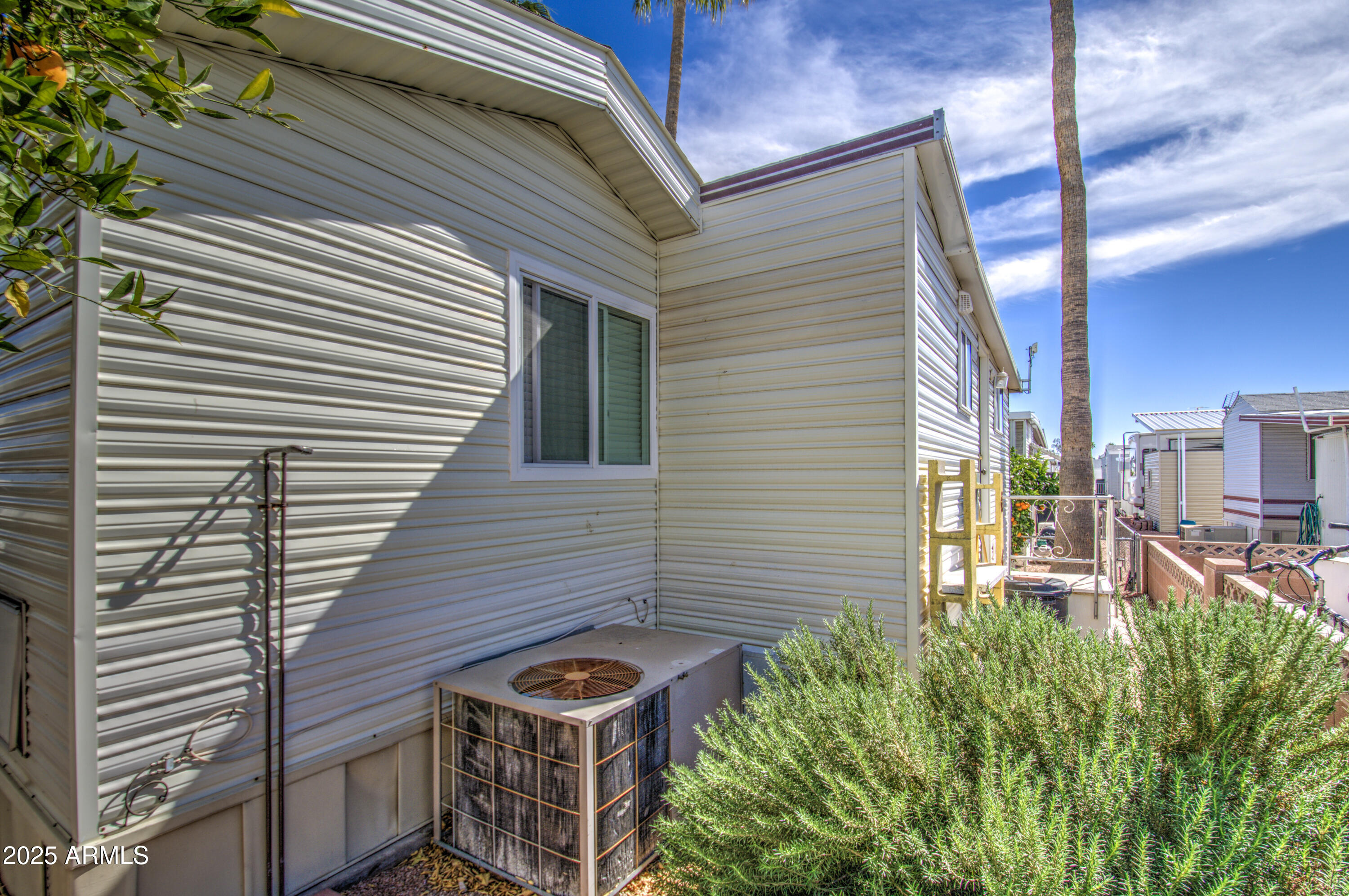 7750 East Broadway Road, Unit 475 Mesa, AZ 85208 - Photo 22 of 34 a front view of a house with garden and plants