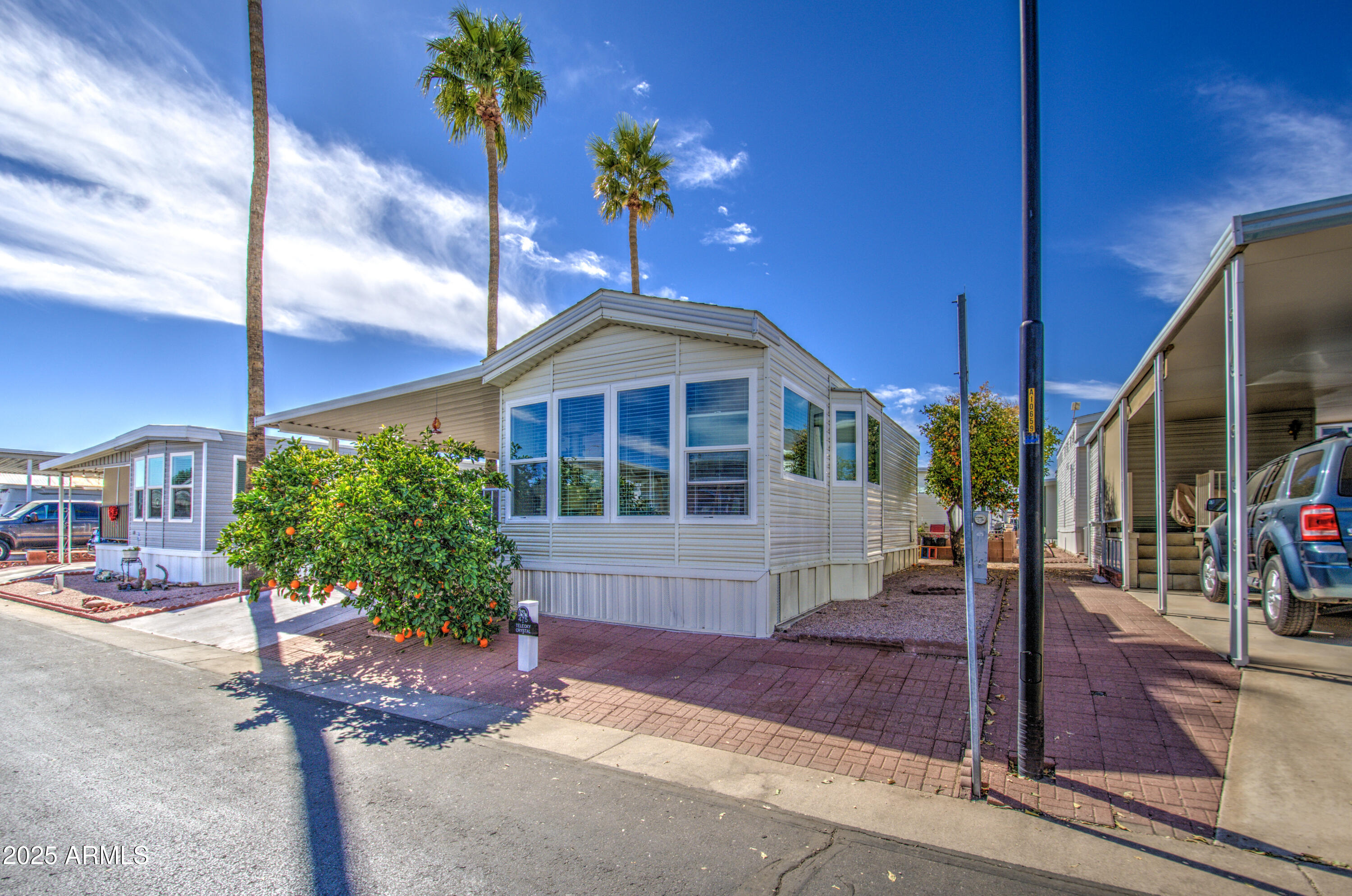 7750 East Broadway Road, Unit 475 Mesa, AZ 85208 - Photo 23 of 34 a front view of a house with a yard