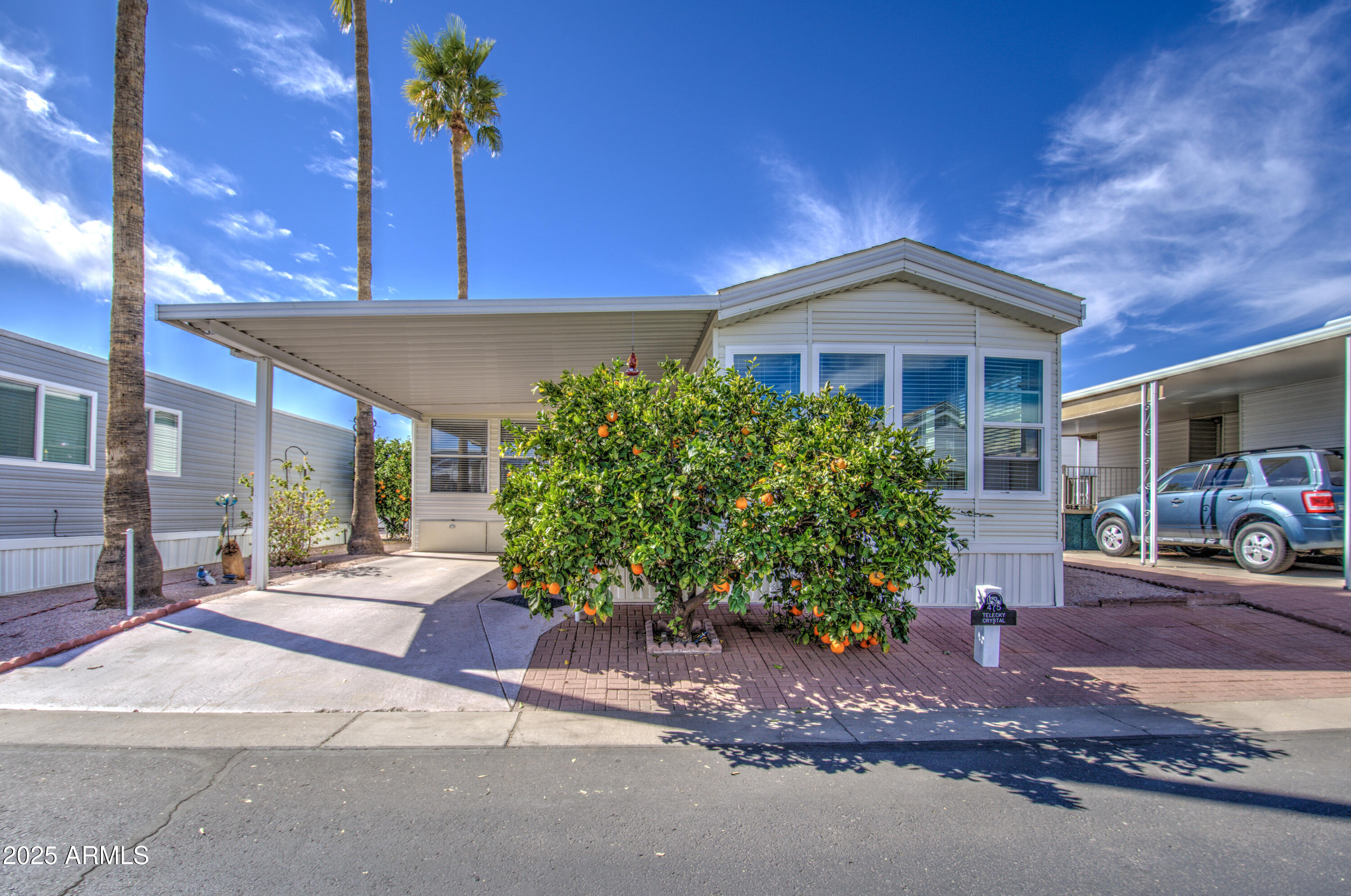 7750 East Broadway Road, Unit 475 Mesa, AZ 85208 - Photo 25 of 34 a front view of a house with a yard