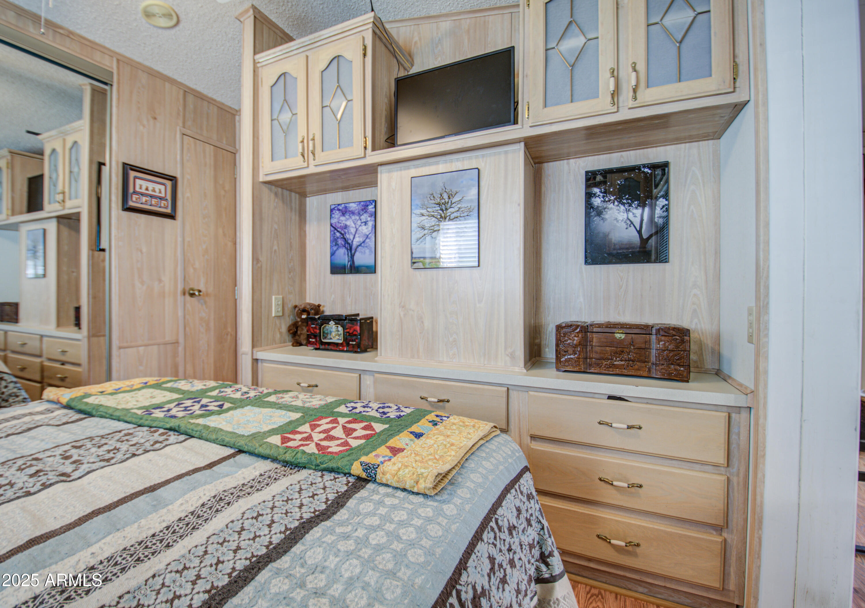 7750 East Broadway Road, Unit 475 Mesa, AZ 85208 - Photo 3 of 34 a bedroom with a bed and a flat screen tv