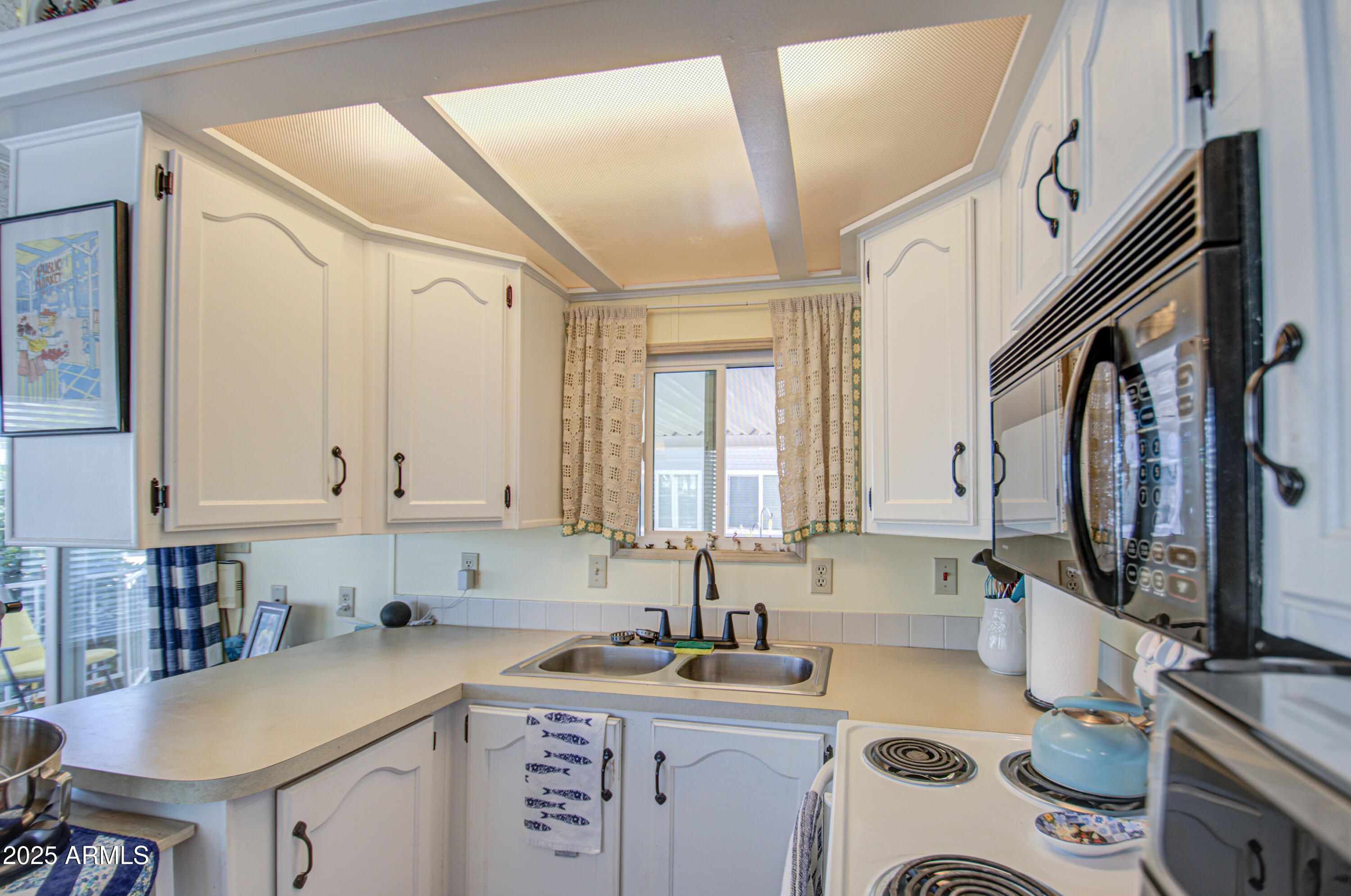 7750 East Broadway Road, Unit 475 Mesa, AZ 85208 - Photo 7 of 34 a kitchen with a sink a stove and cabinets