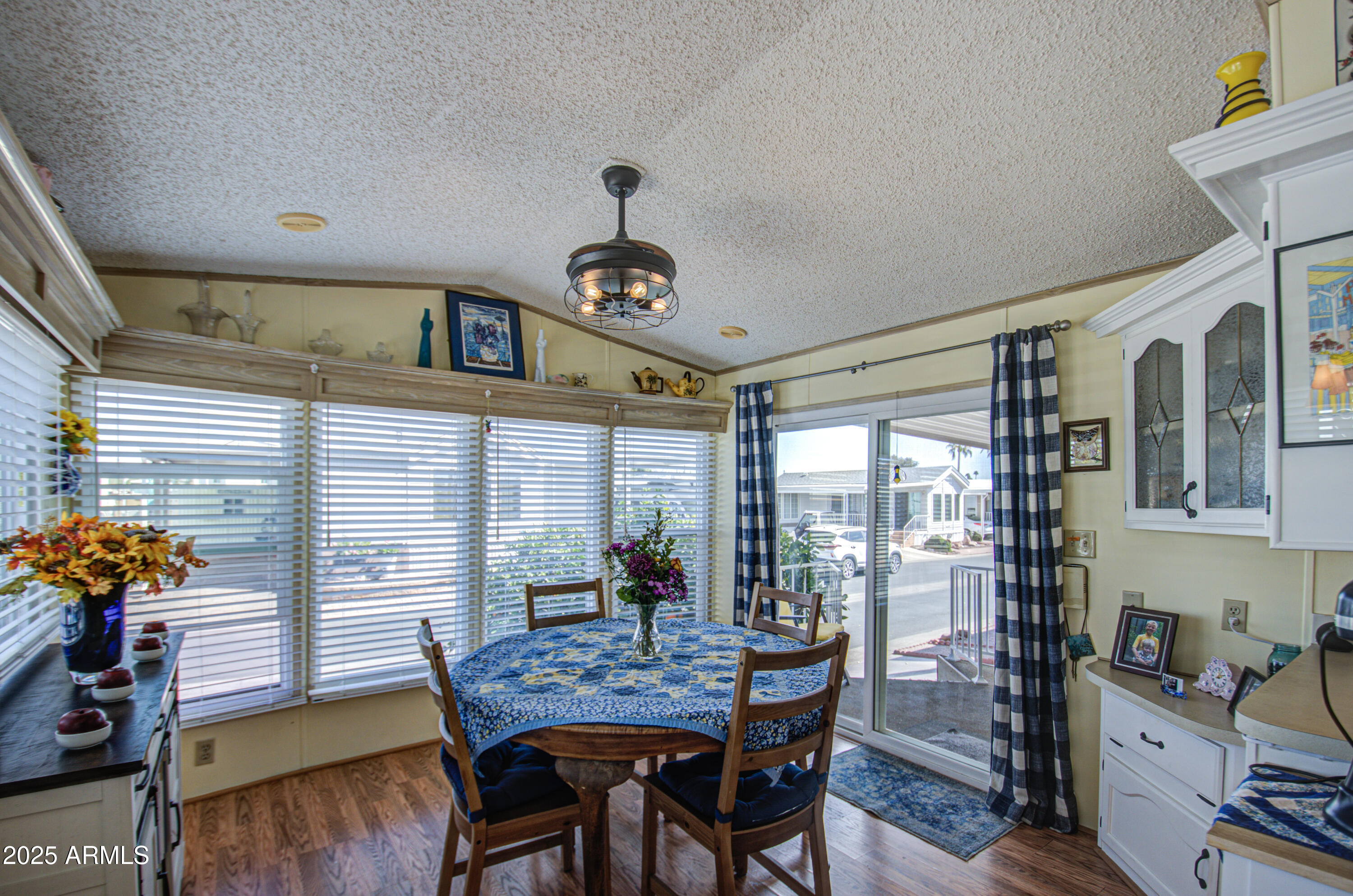 7750 East Broadway Road, Unit 475 Mesa, AZ 85208 - Photo 10 of 34 a view of a dining room with furniture and wooden floor