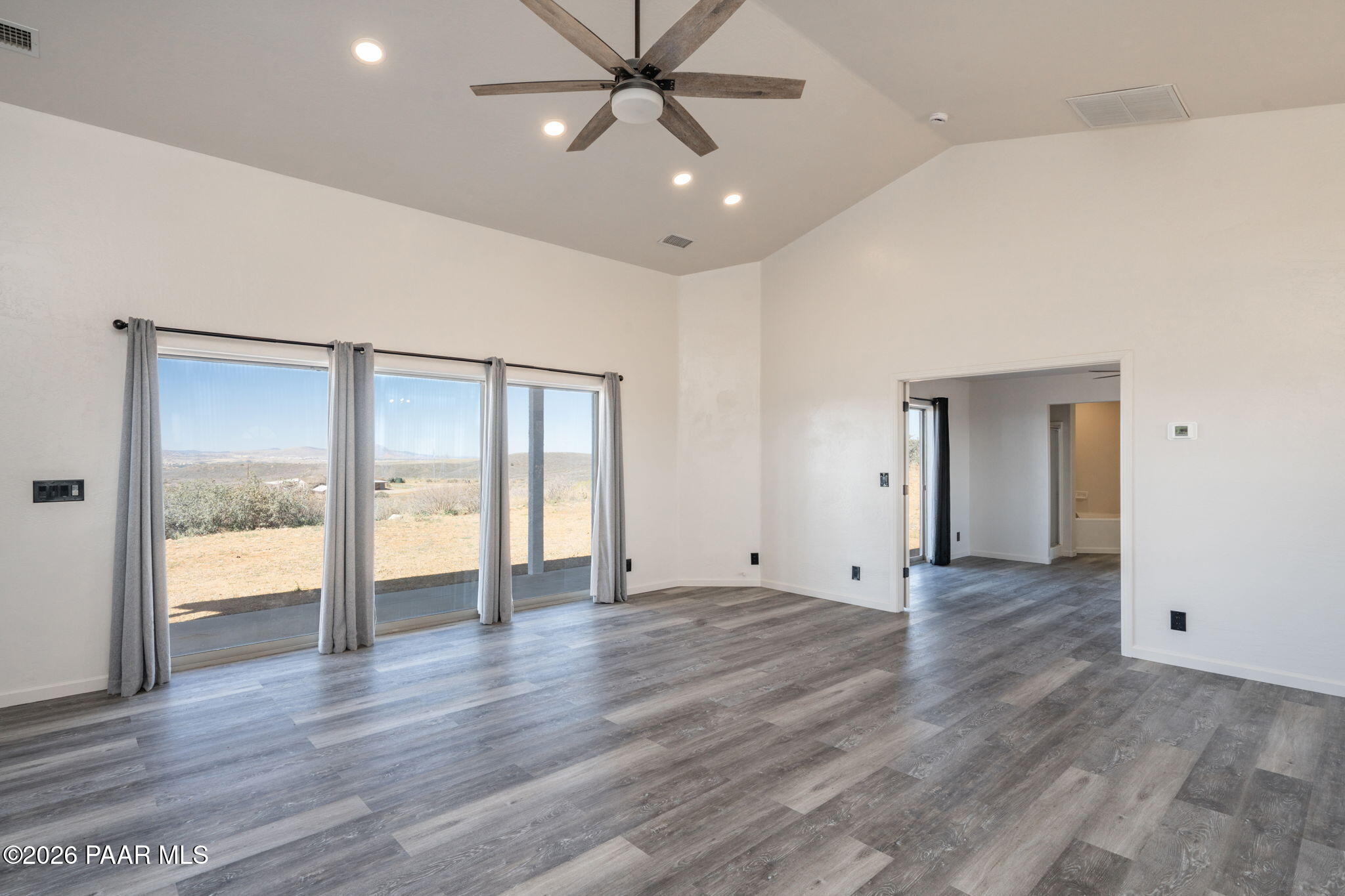 16751 Leprechaun Road Dewey, AZ 86327 - Photo 13 of 46 an empty room with wooden floor and windows