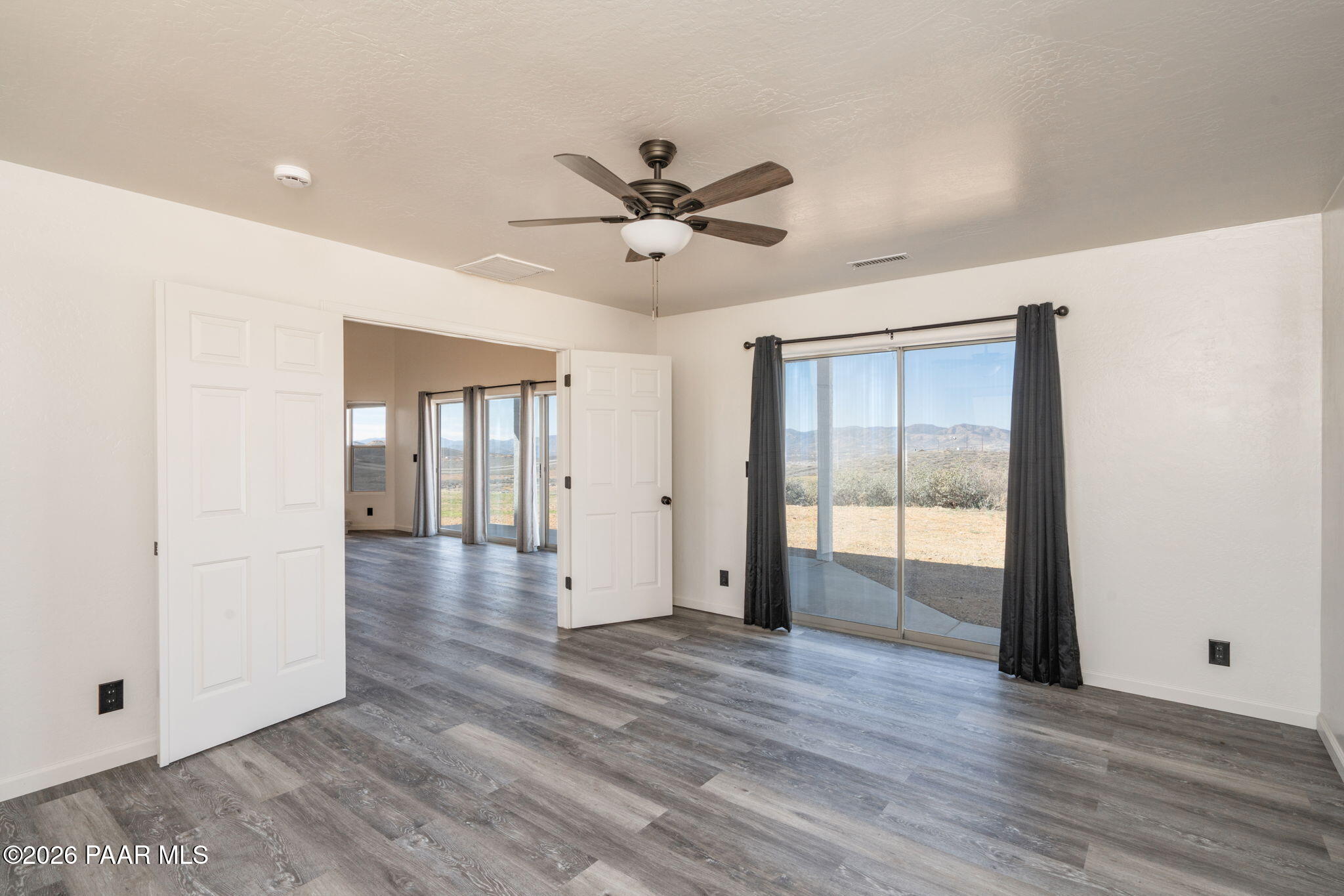 16751 Leprechaun Road Dewey, AZ 86327 - Photo 19 of 46 a view of an empty room with window and wooden floor