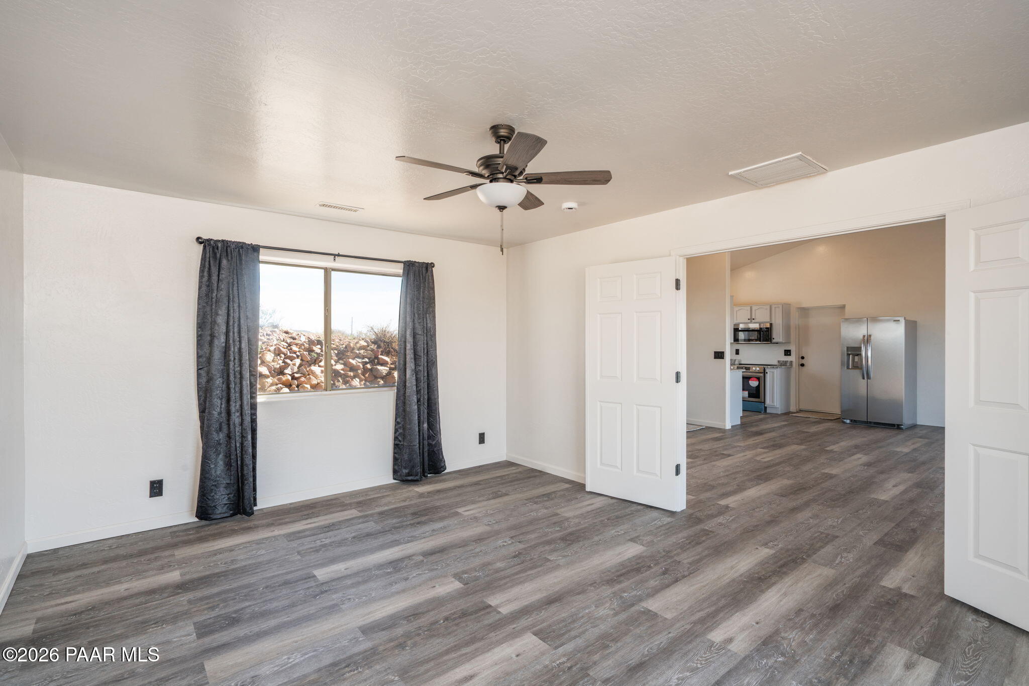16751 Leprechaun Road Dewey, AZ 86327 - Photo 20 of 46 a view of a livingroom with wooden floor and a ceiling fan