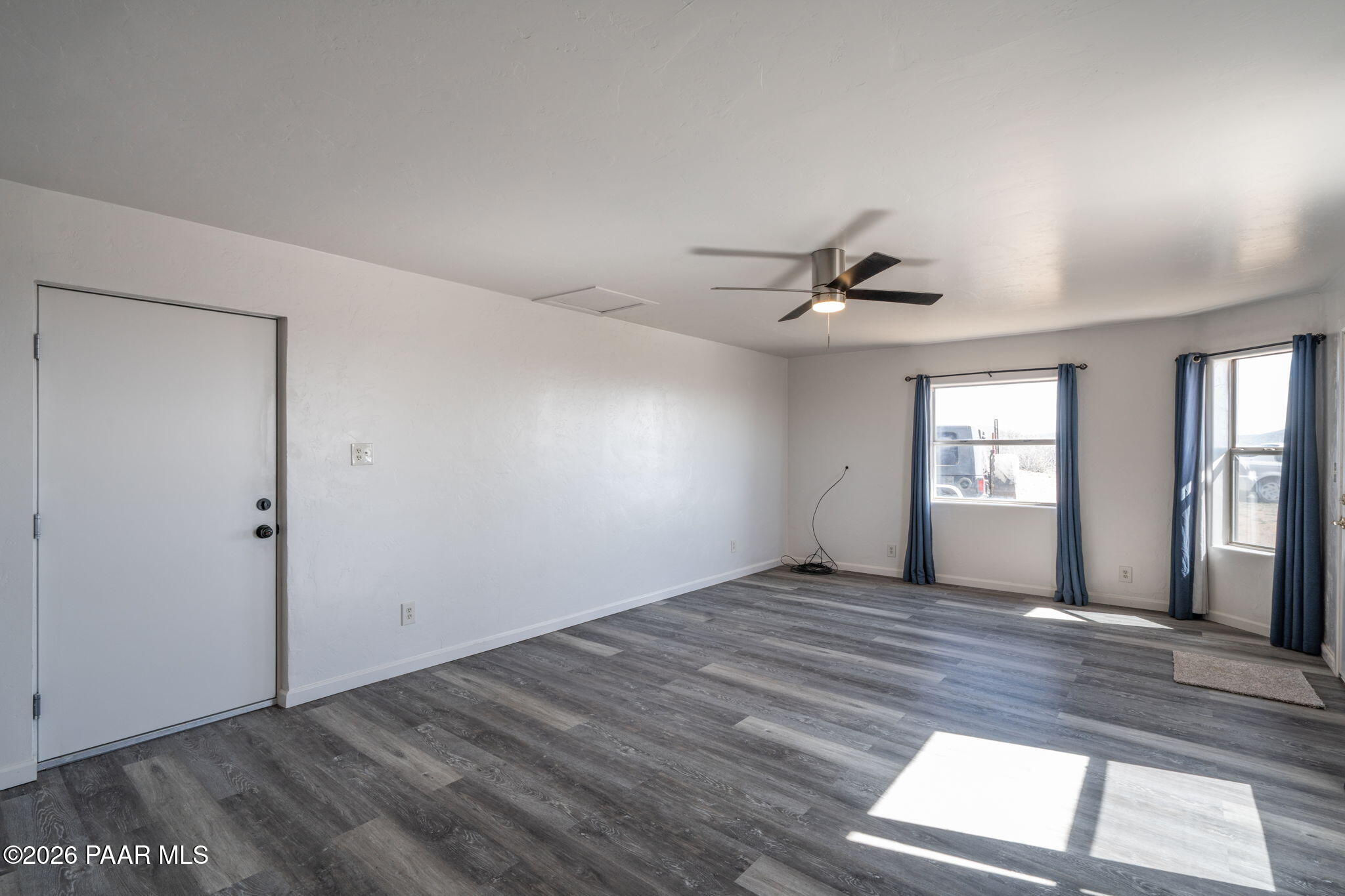 16751 Leprechaun Road Dewey, AZ 86327 - Photo 33 of 46 an empty room with wooden floor and windows