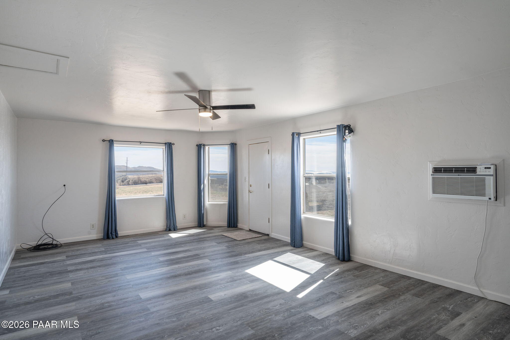 16751 Leprechaun Road Dewey, AZ 86327 - Photo 34 of 46 a view of an empty room with window and wooden floor