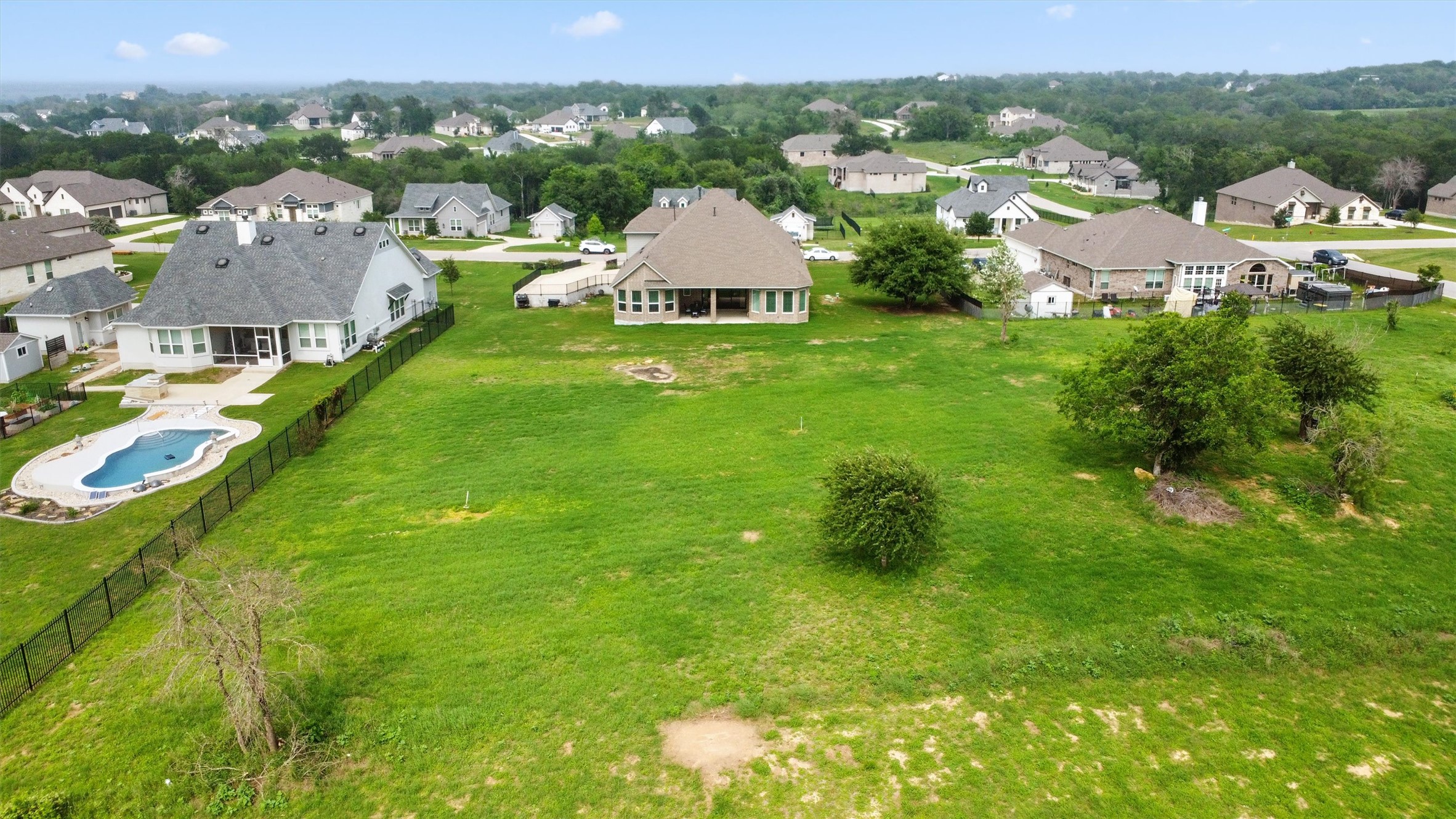 192 Raptor Beak Way Cedar Creek, TX 78612 - Photo 36 of 38 Expansive green space featuring scattered mature trees and a gently sloped terrain