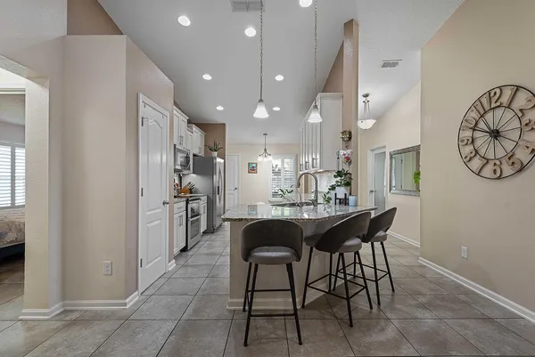 a large kitchen with a table and chairs
