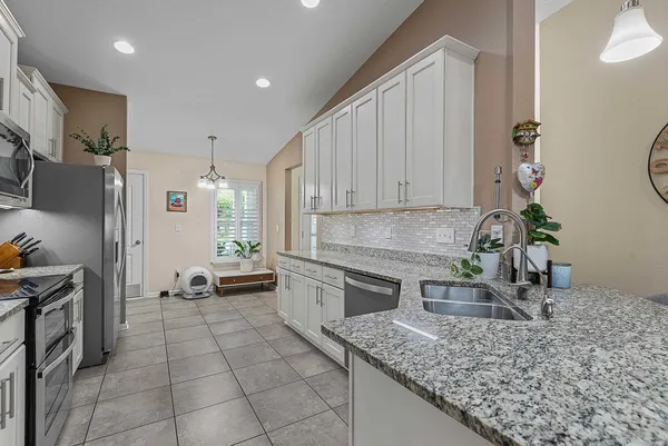 a kitchen with a refrigerator and a sink