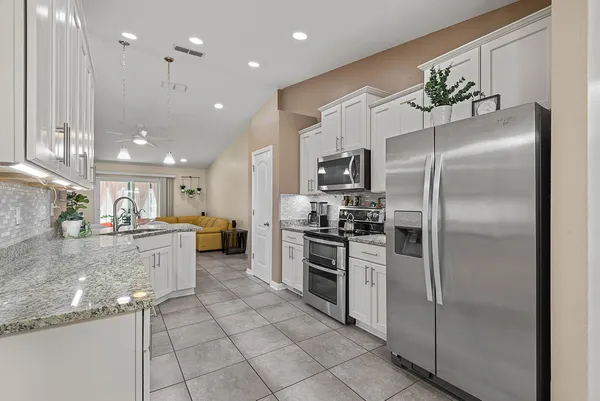 a kitchen with a sink stainless steel appliances and cabinets