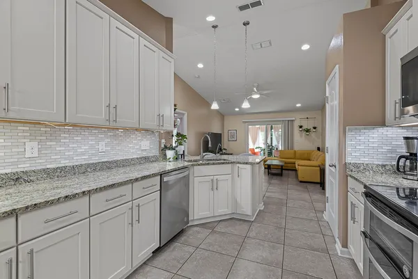 a kitchen with stainless steel appliances granite countertop a stove and a sink