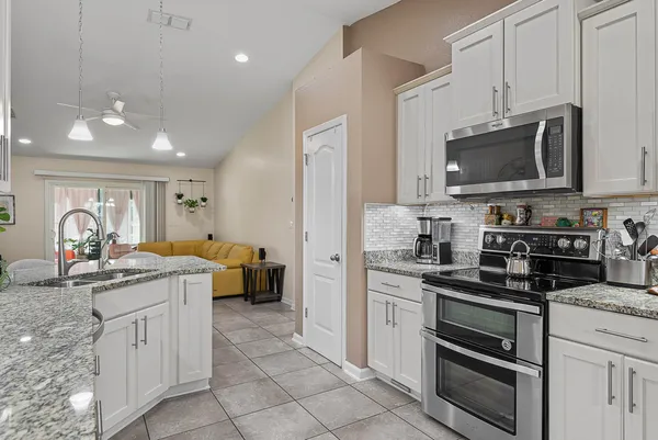 a kitchen with stainless steel appliances granite countertop a refrigerator a sink and dishwasher