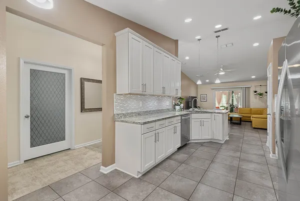 a living room with furniture and a potted plant
