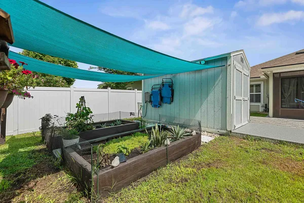 a view of a house with a yard patio and slide