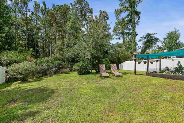 a view of a house with backyard porch and sitting area