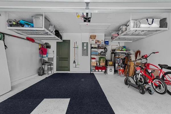 an aerial view of a house with a yard and tennis court