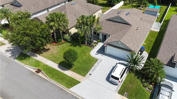 an aerial view of a house with yard swimming pool and outdoor seating