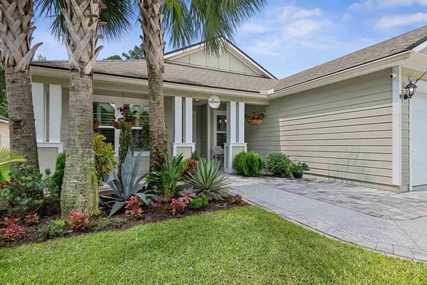 a view of a house with a small yard and plants