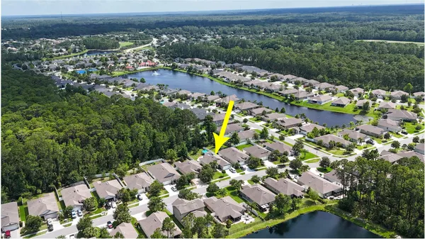an aerial view of multiple houses with yard
