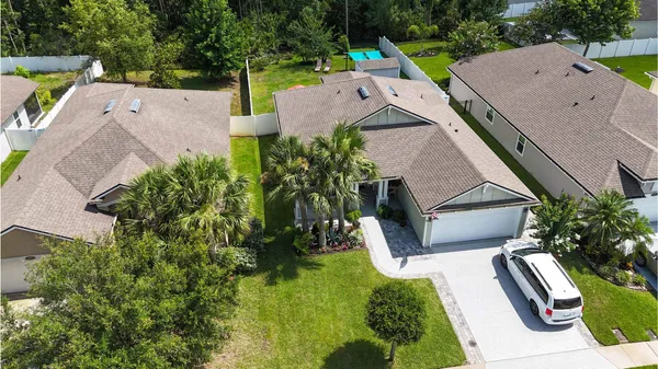 an aerial view of residential houses with outdoor space and swimming pool