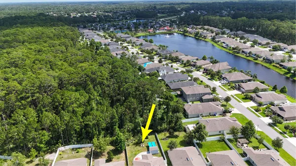 an aerial view of a house with garden space and street view