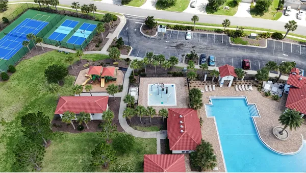 an aerial view of a house with a swimming pool outdoor seating and yard