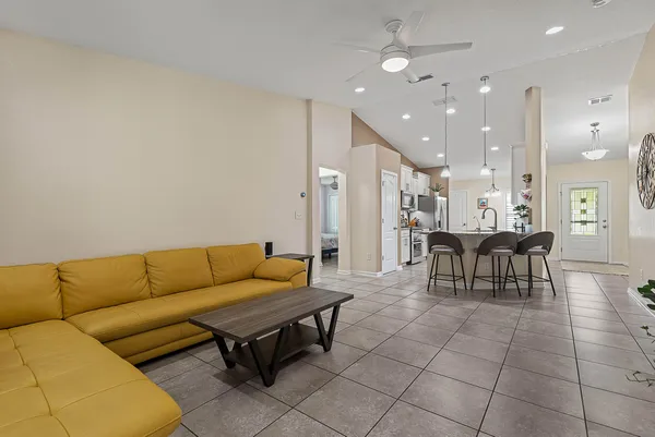 a living room with furniture and flowers