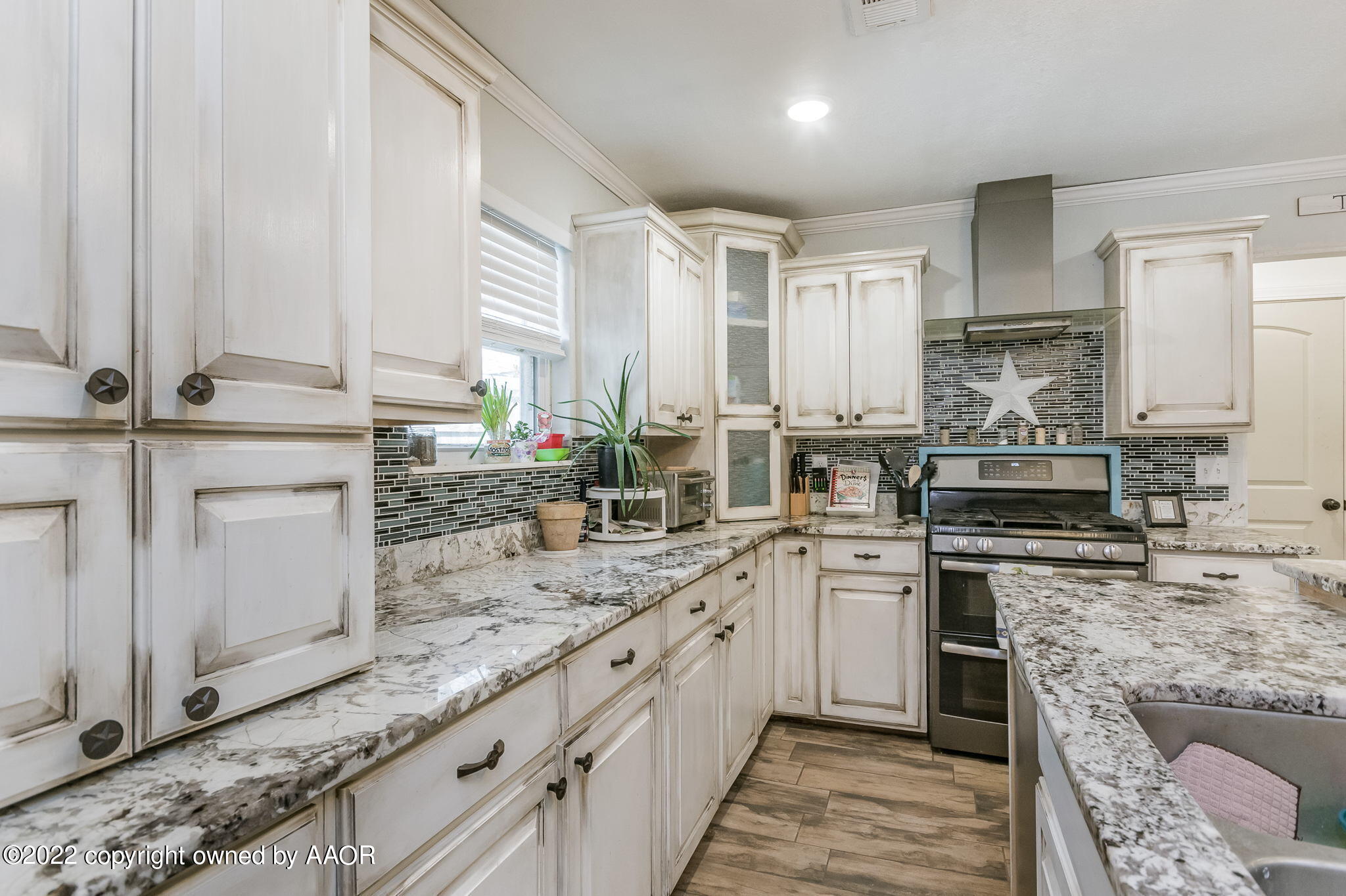 4801 Gary Lane Amarillo, TX 79110 - Photo 6 of 21 a kitchen with stainless steel appliances granite countertop a stove sink and cabinets